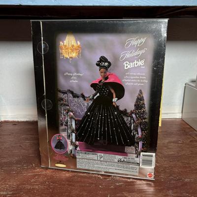 LOT 297: NIP 1998 Happy Holiday Barbie, 1985 Barbie Magazine & 1979 Sunshine Family Coloring Book