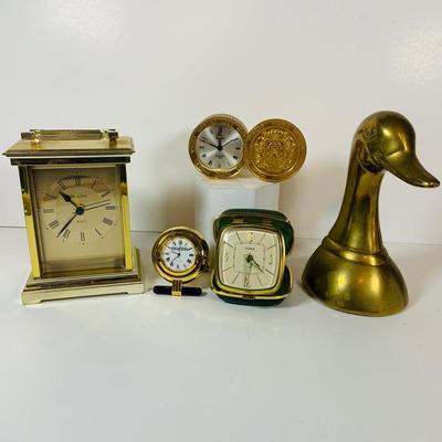 LOT 299: Clocks and Quacks - Brass Duck Book End, Bulova Quartz Mantle Clock, Florin Travel Clock, Swiza Swiss Coin Shaped Alarm Clock...