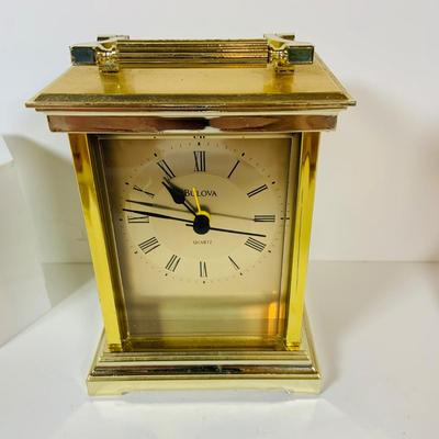 LOT 299: Clocks and Quacks - Brass Duck Book End, Bulova Quartz Mantle Clock, Florin Travel Clock, Swiza Swiss Coin Shaped Alarm Clock...