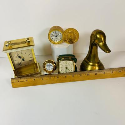 LOT 299: Clocks and Quacks - Brass Duck Book End, Bulova Quartz Mantle Clock, Florin Travel Clock, Swiza Swiss Coin Shaped Alarm Clock...