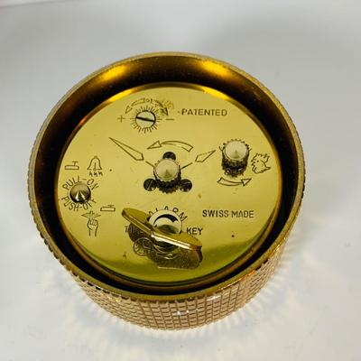 LOT 299: Clocks and Quacks - Brass Duck Book End, Bulova Quartz Mantle Clock, Florin Travel Clock, Swiza Swiss Coin Shaped Alarm Clock...