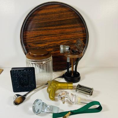 LOT 307: Pipes, Pipe Holder, Tobacco Jar, Cigarette Case, Crystal Bottle Stops Formica Tray, Brass Eagle Cane Handle and More