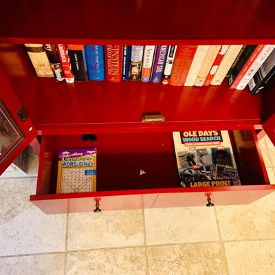 LOT 330: Red Wooden Book Case with Drawer and Glass Front Doors Books, and Book Ends