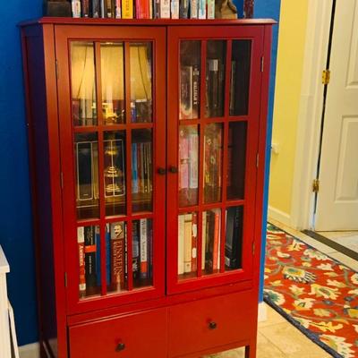 LOT 330: Red Wooden Book Case with Drawer and Glass Front Doors Books, and Book Ends