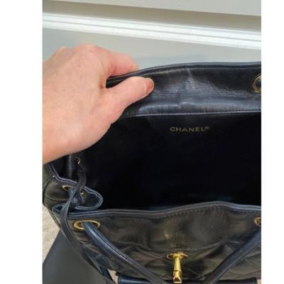 Sale Photo Thumbnail #49: Authentic Chanel backpack large size.  Very versatile, great vintage condition, 24 K plated hardware is heavy and in shining gold color.  Very soft lamb skin leather.  Unisex great for daily use.  12x12”. Opens wide.  Inside clean.  No rips or tears.  A