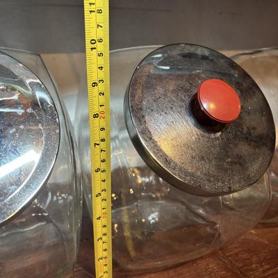 LOT 277-429: Set of Large Clear Glass Tilted Candy/Cookie Jar with Metal Lids & Red Knobs, Southern Living, Betty Crocker Cookbooks...