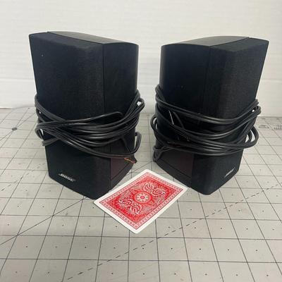 Sale Photo Thumbnail #1169: Dual-cube satellite speakers with a swiveling mechanism for adjustable sound dispersion.