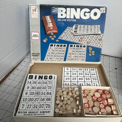 Sale Photo Thumbnail #1316: This vintage set includes original Bingo cards, numbered markers, a call sheet, and spinner, all housed in its iconic retro packaging.