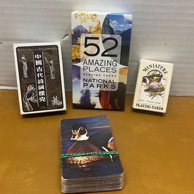 Sale Photo Thumbnail #1378: Explore a world of design with this unique set of 4 themed playing card decks, each offering its own artistic flair