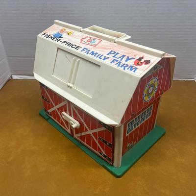 Sale Photo Thumbnail #1412: Step back into classic childhood with this vintage Fisher-Price Play Family Farm set, featuring the iconic red-and-white barn with working doors. Has some coloring on barn.