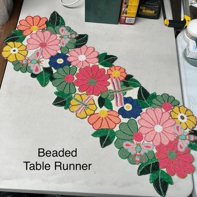 Sale Photo Thumbnail #1517: Vibrant handmade runner featuring colorful beaded flowers and leaves, perfect for brightening up dining or accent tables.