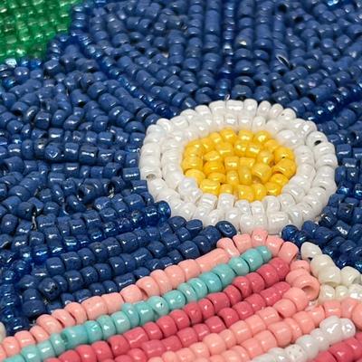 Sale Photo Thumbnail #1518: Vibrant handmade runner featuring colorful beaded flowers and leaves, perfect for brightening up dining or accent tables.