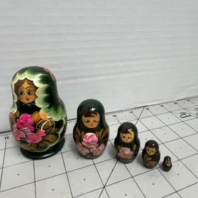 Sale Photo Thumbnail #1587: Colorful matryoshka doll collections, each featuring traditional floral designs with multiple nested pieces of varying sizes.