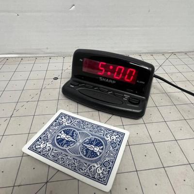 Sale Photo Thumbnail #1780: Sharp brand digital alarm clock with large red LED display and snooze function.