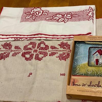 Ceramic wall plaque & red embroidered table cloths