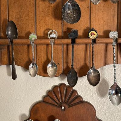 SOUVENIR SPOONS IN WOODEN RACKS
