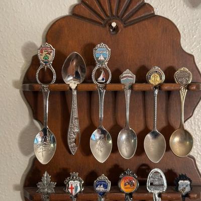 SOUVENIR SPOONS IN WOODEN RACKS