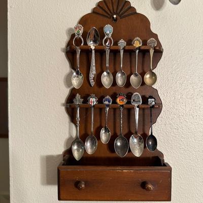 SOUVENIR SPOONS IN WOODEN RACKS