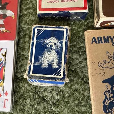 DECKS OF CARDS INCLUDING ONE HUGE DECK PLUS A BOOK ON TRICKS AND STUNTS WITH PLAYING CARDS