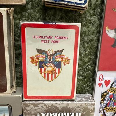 DECKS OF CARDS INCLUDING ONE HUGE DECK PLUS A BOOK ON TRICKS AND STUNTS WITH PLAYING CARDS