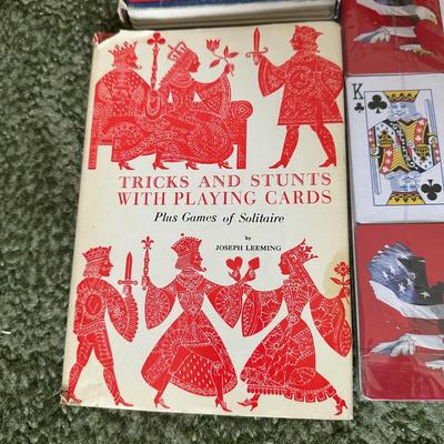 DECKS OF CARDS INCLUDING ONE HUGE DECK PLUS A BOOK ON TRICKS AND STUNTS WITH PLAYING CARDS