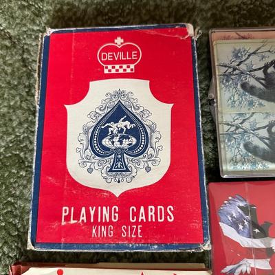 DECKS OF CARDS INCLUDING ONE HUGE DECK PLUS A BOOK ON TRICKS AND STUNTS WITH PLAYING CARDS
