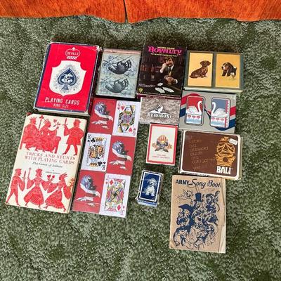 DECKS OF CARDS INCLUDING ONE HUGE DECK PLUS A BOOK ON TRICKS AND STUNTS WITH PLAYING CARDS