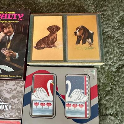 DECKS OF CARDS INCLUDING ONE HUGE DECK PLUS A BOOK ON TRICKS AND STUNTS WITH PLAYING CARDS