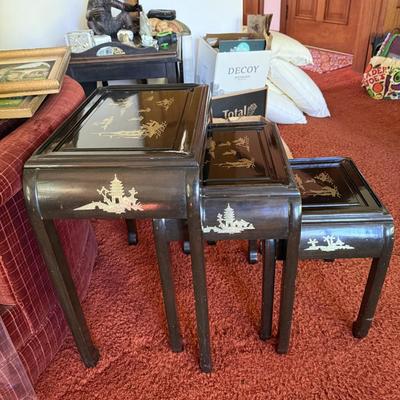 Sale Photo Thumbnail #27: This set of three vintage nesting tables from China, dating between 1900-1940, features a black lacquer finish with intricate mother of pearl and jade stone inlays. The tables measure 22w x 14d x 26h, 17w x 13d x 22h, and 13w x 12.5d x 17.5h, respectively