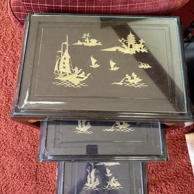 Sale Photo Thumbnail #25: This set of three vintage nesting tables from China, dating between 1900-1940, features a black lacquer finish with intricate mother of pearl and jade stone inlays. The tables measure 22w x 14d x 26h, 17w x 13d x 22h, and 13w x 12.5d x 17.5h, respectively