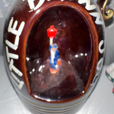 MUSICAL LITTLE BROWN JUG, DOLL AND METAL TIN