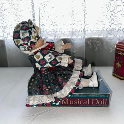 MUSICAL LITTLE BROWN JUG, DOLL AND METAL TIN