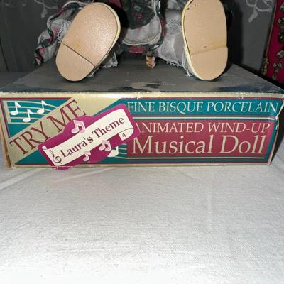 MUSICAL LITTLE BROWN JUG, DOLL AND METAL TIN