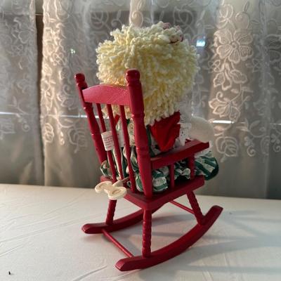 THREE SMALLER DOLLS PLUS A WICKER DOLL CHAIR