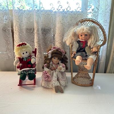 THREE SMALLER DOLLS PLUS A WICKER DOLL CHAIR