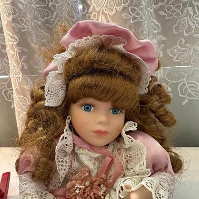 THREE SMALLER DOLLS PLUS A WICKER DOLL CHAIR