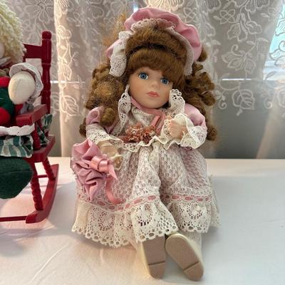 THREE SMALLER DOLLS PLUS A WICKER DOLL CHAIR