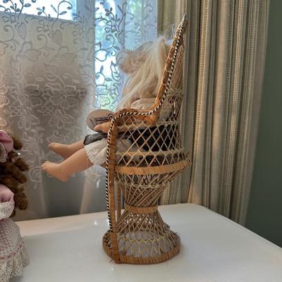THREE SMALLER DOLLS PLUS A WICKER DOLL CHAIR
