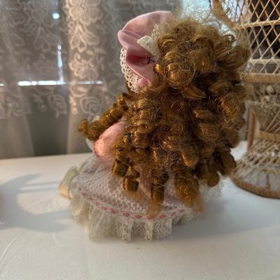 THREE SMALLER DOLLS PLUS A WICKER DOLL CHAIR