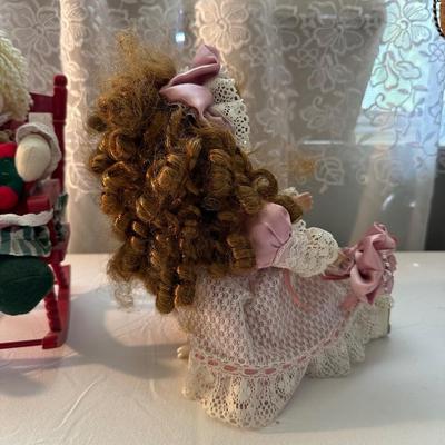 THREE SMALLER DOLLS PLUS A WICKER DOLL CHAIR