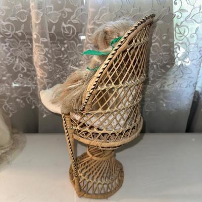 3 SMALLER DOLLS PLUS A WICKER DOLL CHAIR