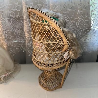 3 SMALLER DOLLS PLUS A WICKER DOLL CHAIR