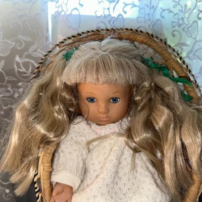 3 SMALLER DOLLS PLUS A WICKER DOLL CHAIR