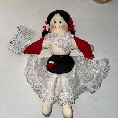 3 SMALLER DOLLS PLUS A WICKER DOLL CHAIR