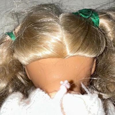 3 SMALLER DOLLS PLUS A WICKER DOLL CHAIR