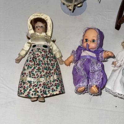 SMALL VINTAGE DOLLS AND A WOODEN ROCKING CHAIR