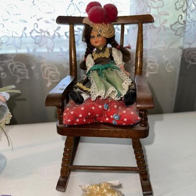 SMALL VINTAGE DOLLS AND A WOODEN ROCKING CHAIR
