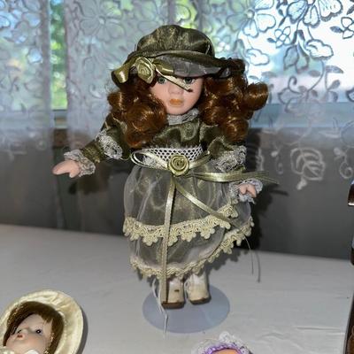 SMALL VINTAGE DOLLS AND A WOODEN ROCKING CHAIR