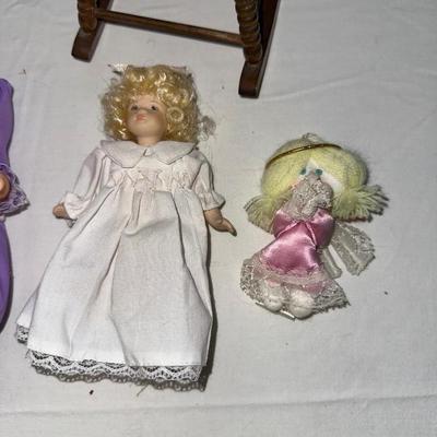 SMALL VINTAGE DOLLS AND A WOODEN ROCKING CHAIR