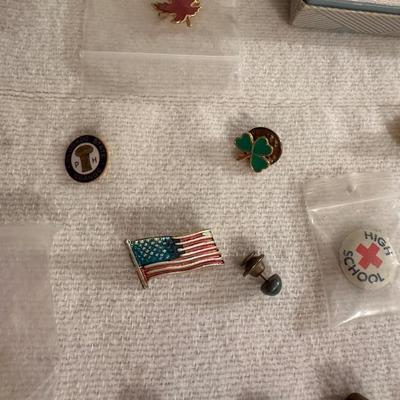 A VARIETY OF PINS AND BUTTONS